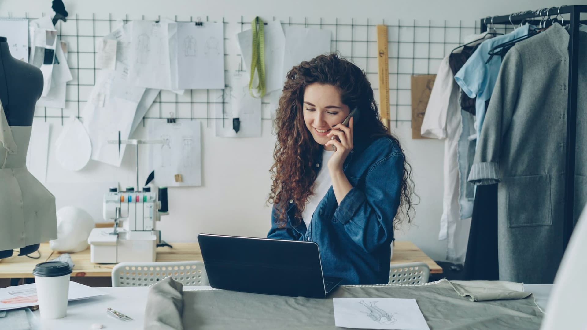 A business owner on the phone at her laptop